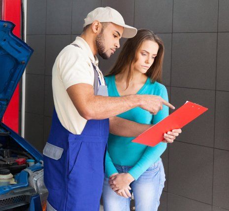 Car technician talking to his client