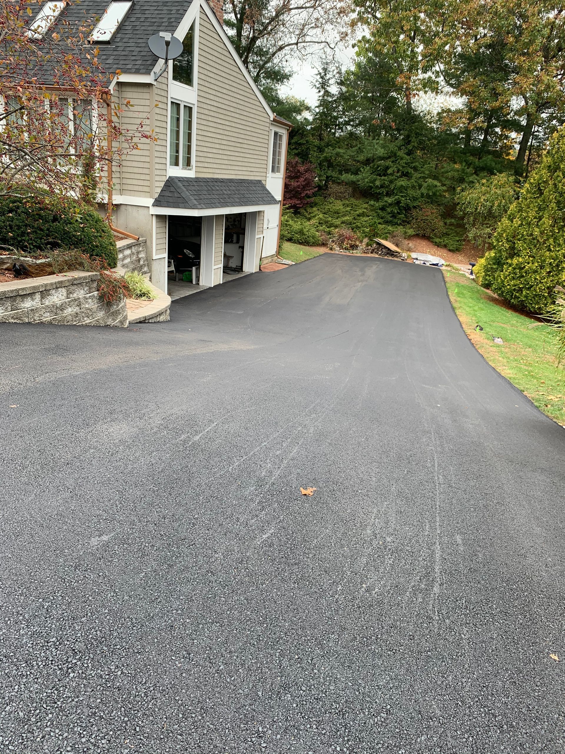 A driveway leading to a house with a garage.
