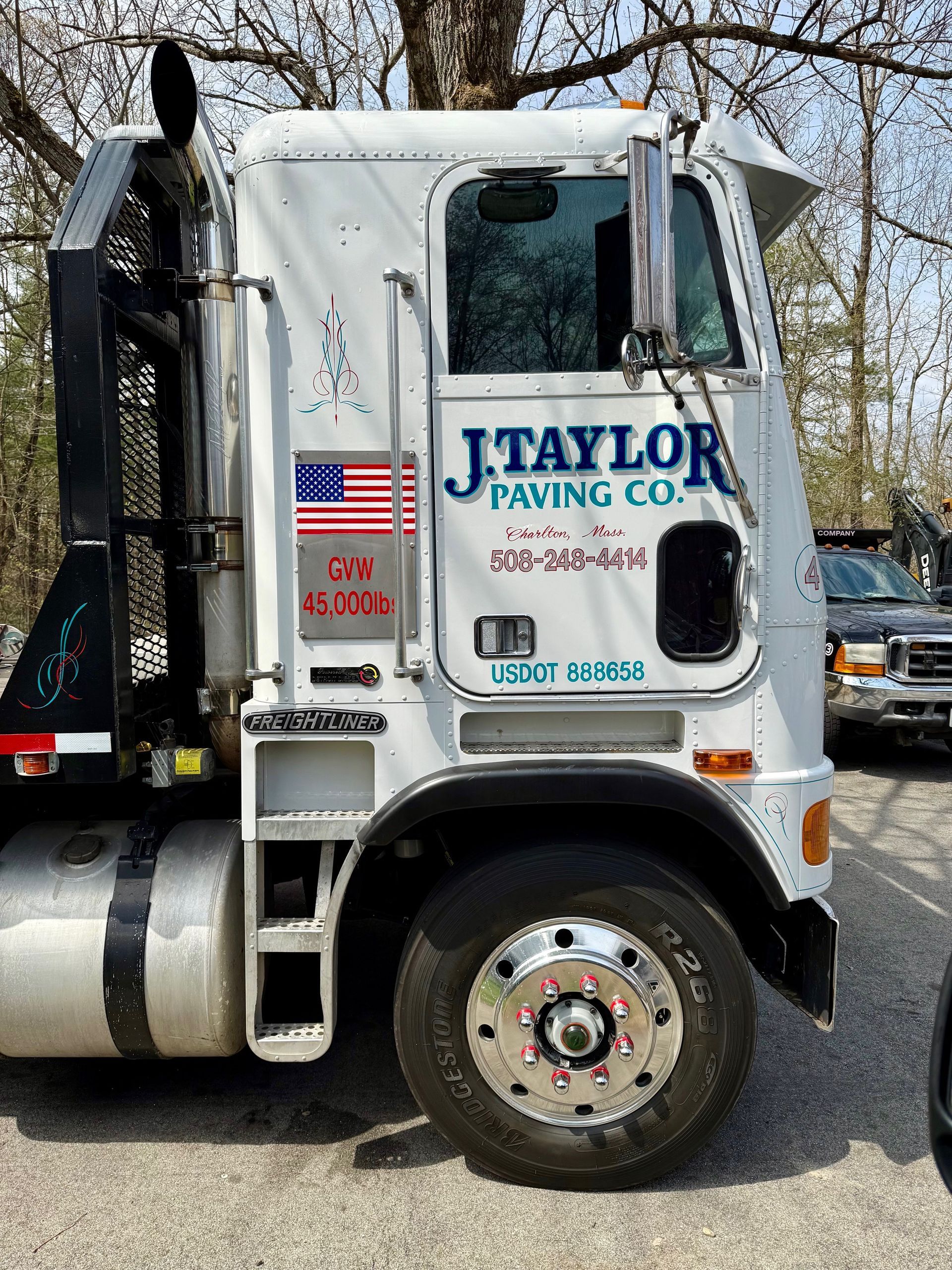 A white truck is parked in a parking lot.