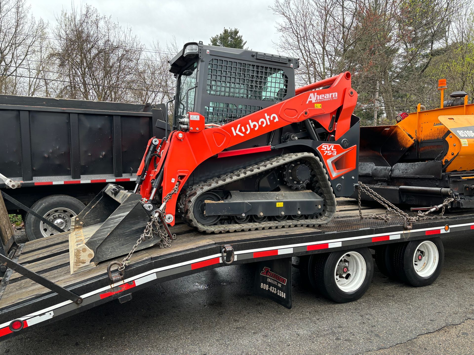 A bulldozer is sitting on top of a trailer.
