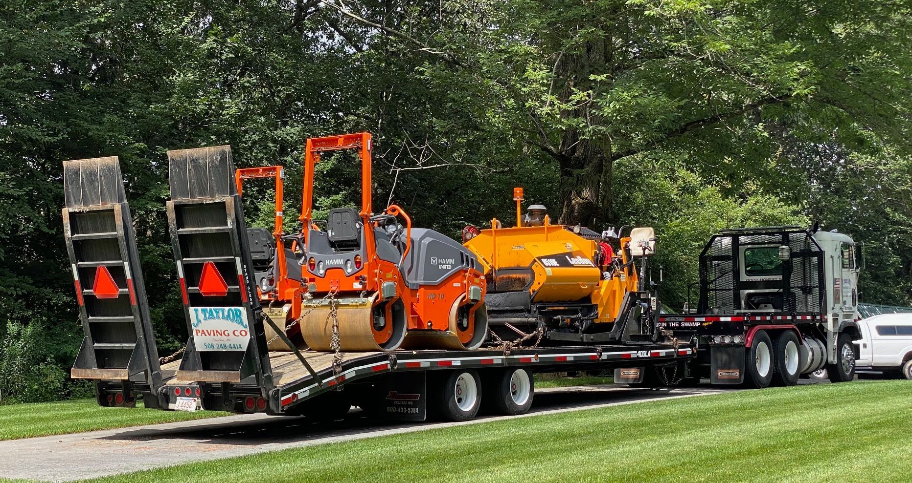 A truck is carrying a bunch of machinery on a trailer.