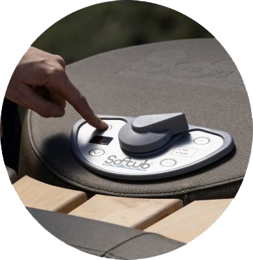 Hand pressing a button on a Softub hot tub control panel.