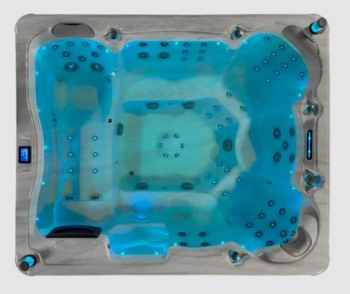 Overhead view of a lit, blue hot tub with multiple jet nozzles and built-in steps, set against a light gray border.