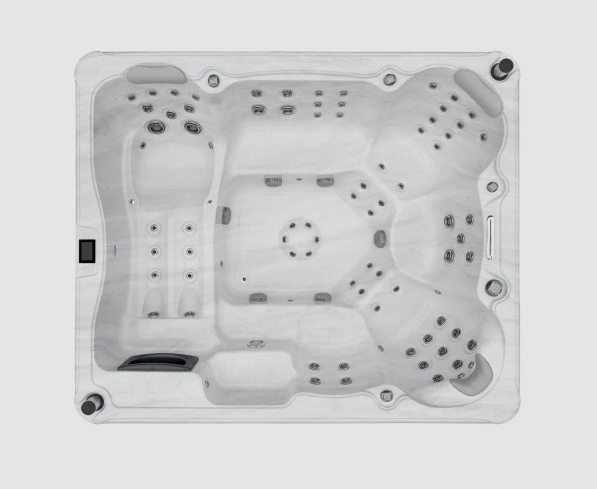 Overhead view of a white hot tub with multiple jet configurations.