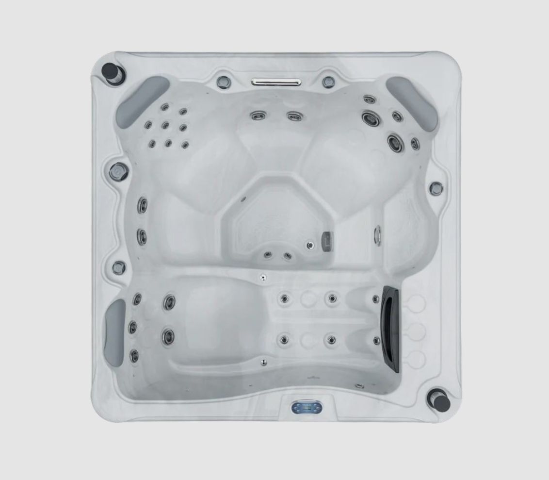 Overhead view of a light gray square hot tub with multiple seating areas and jets.