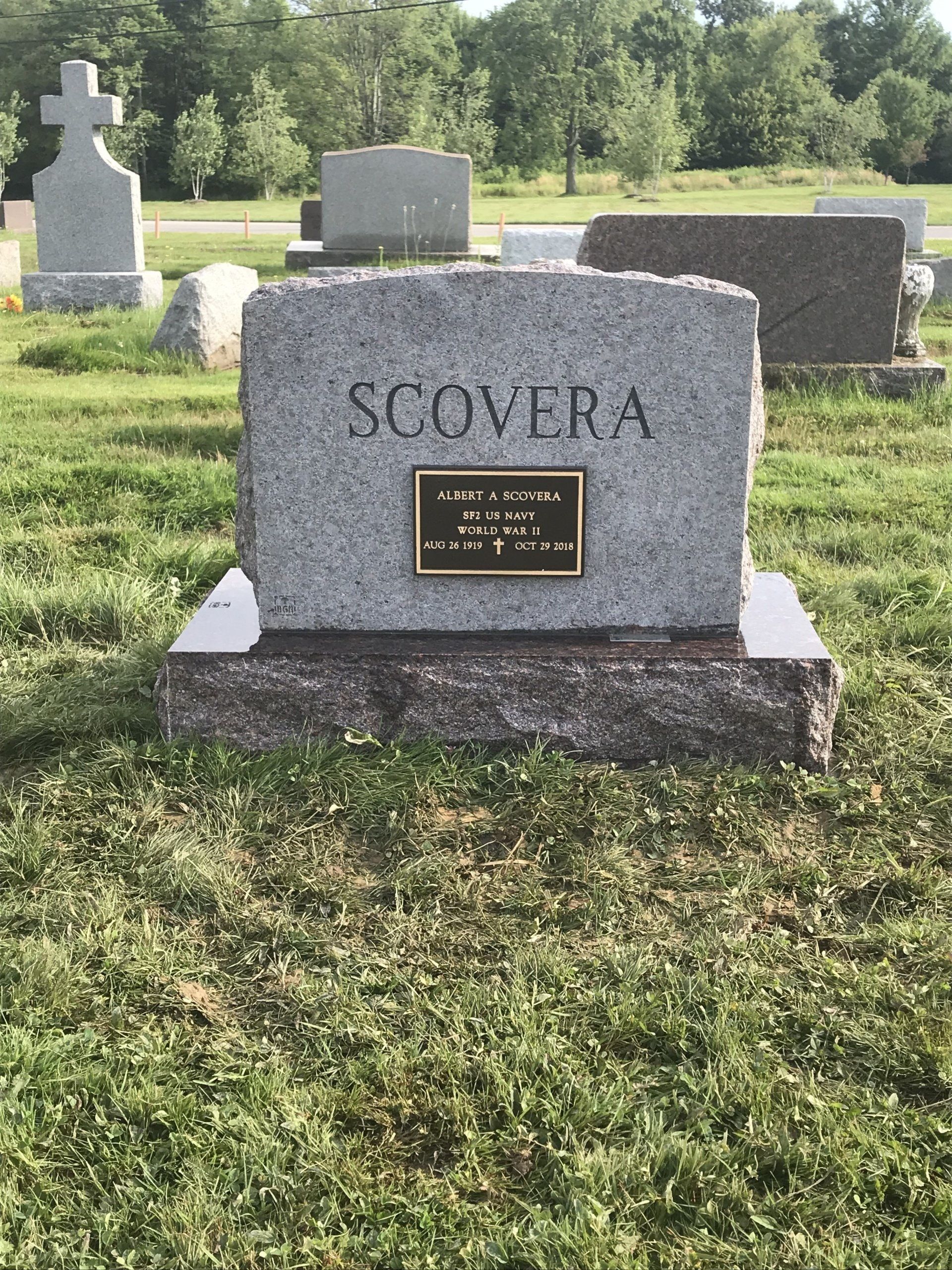 A gravestone in a cemetery with the name scovera on it