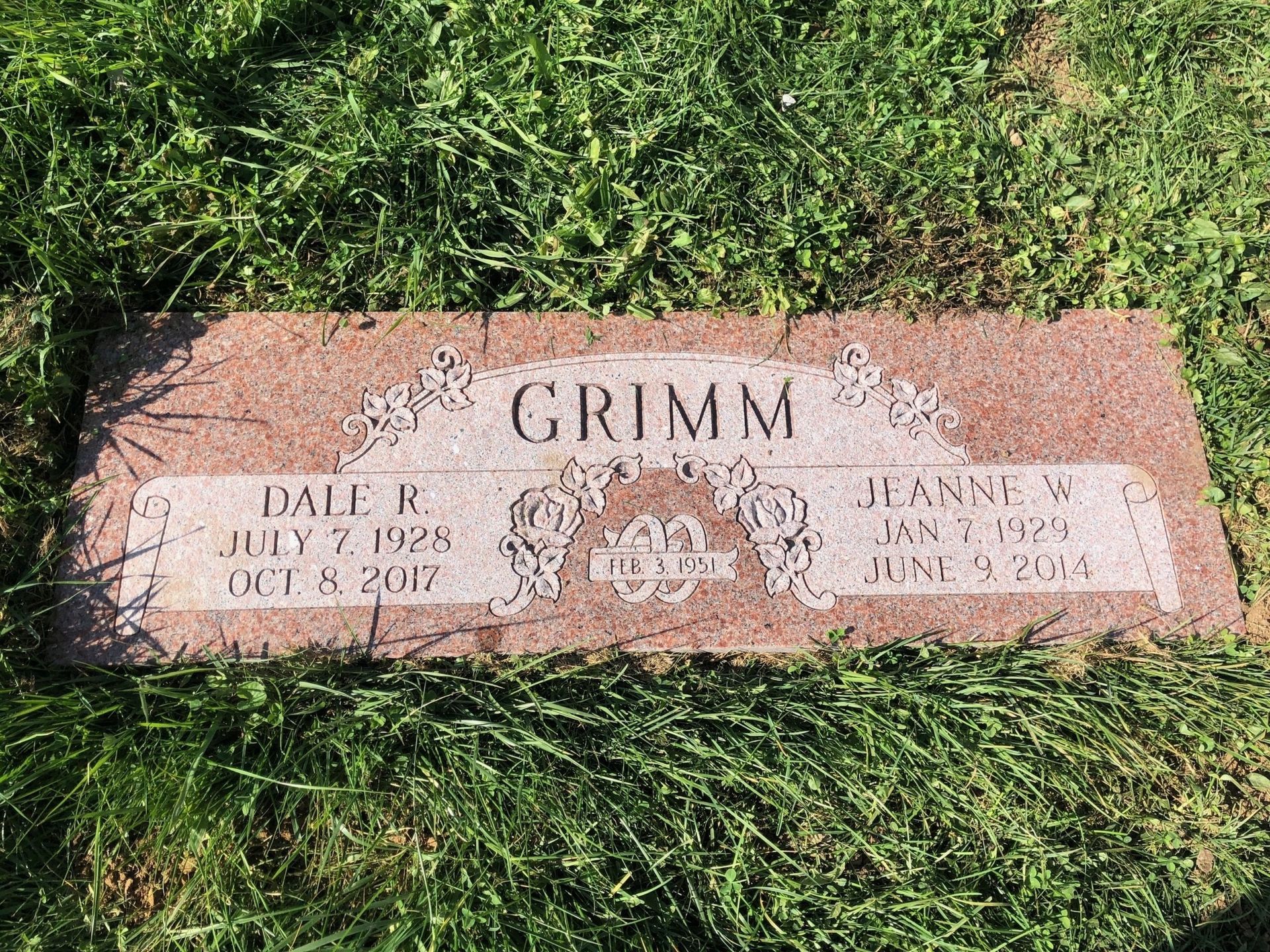 A gravestone in a cemetery with the name grimm on it.