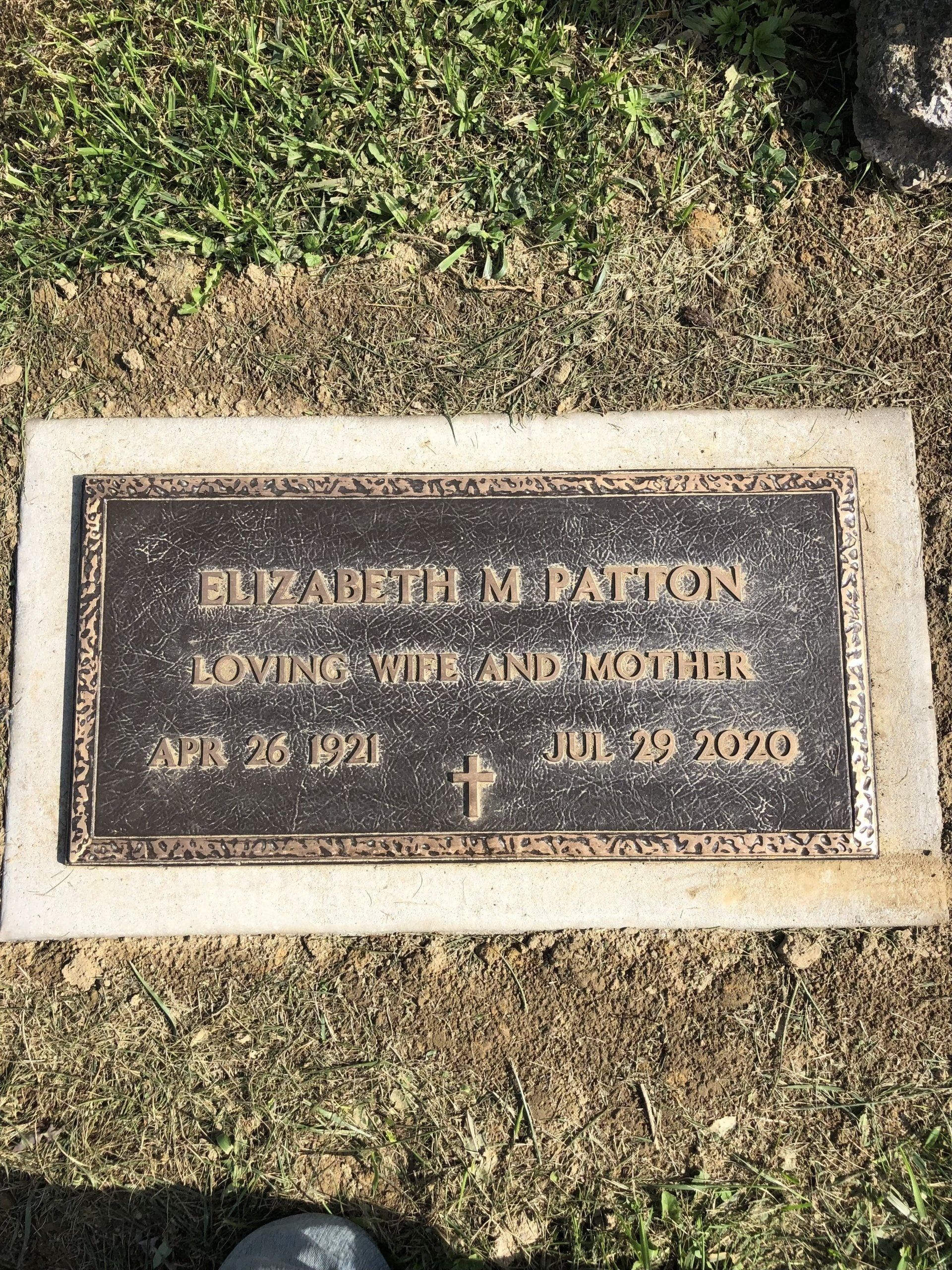 A gravestone for elizabeth m. patton is sitting in the grass.