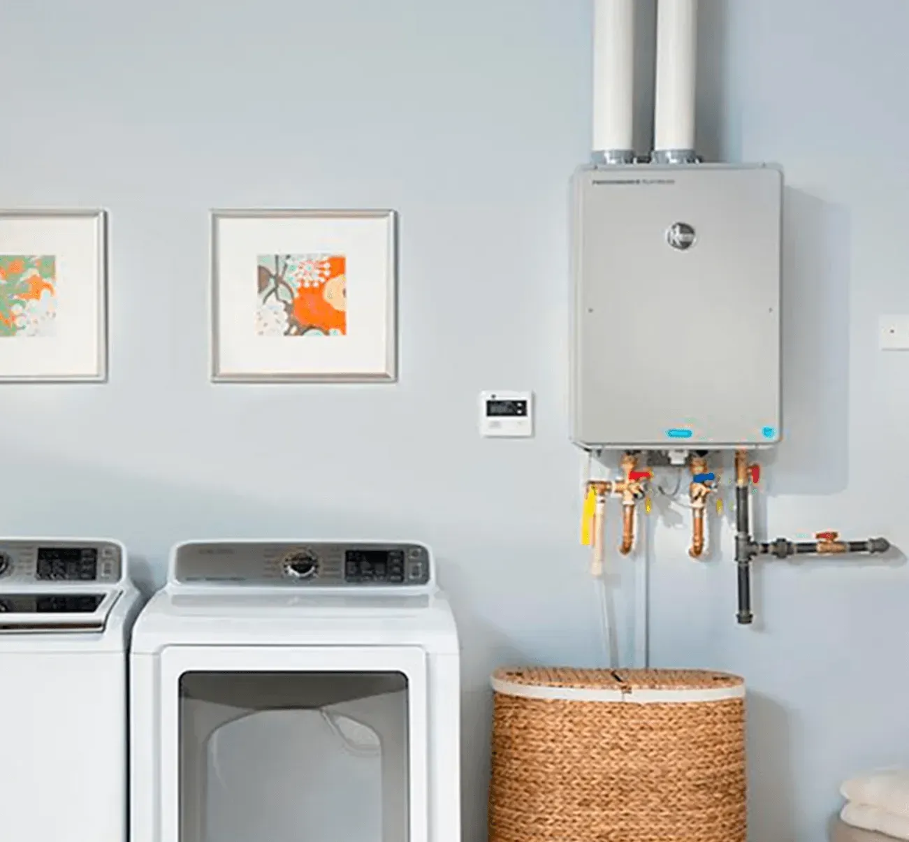 Tankless water heater on laundry room wall, next to washer and dryer.