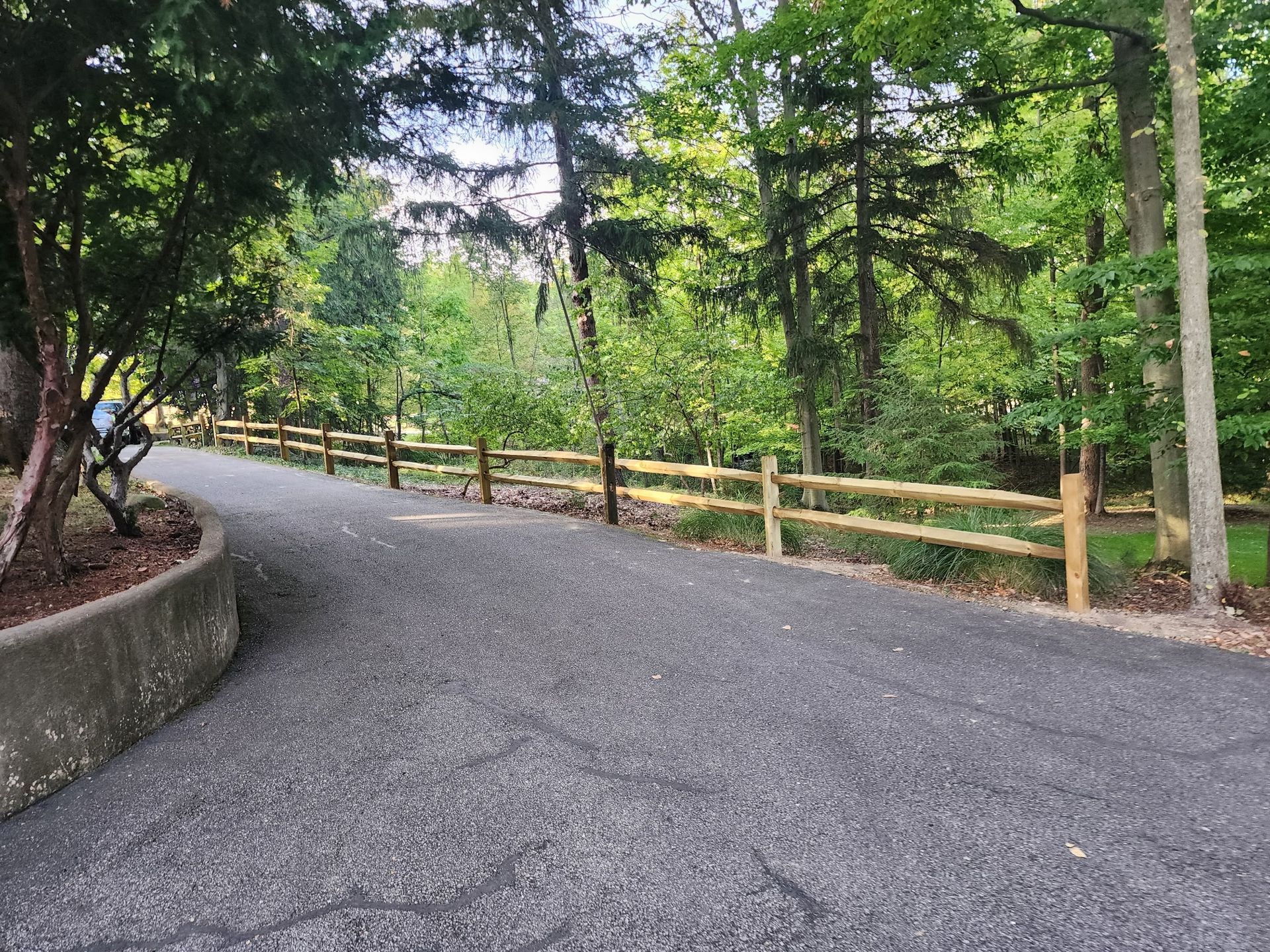 A road with a wooden fence on the side of it
