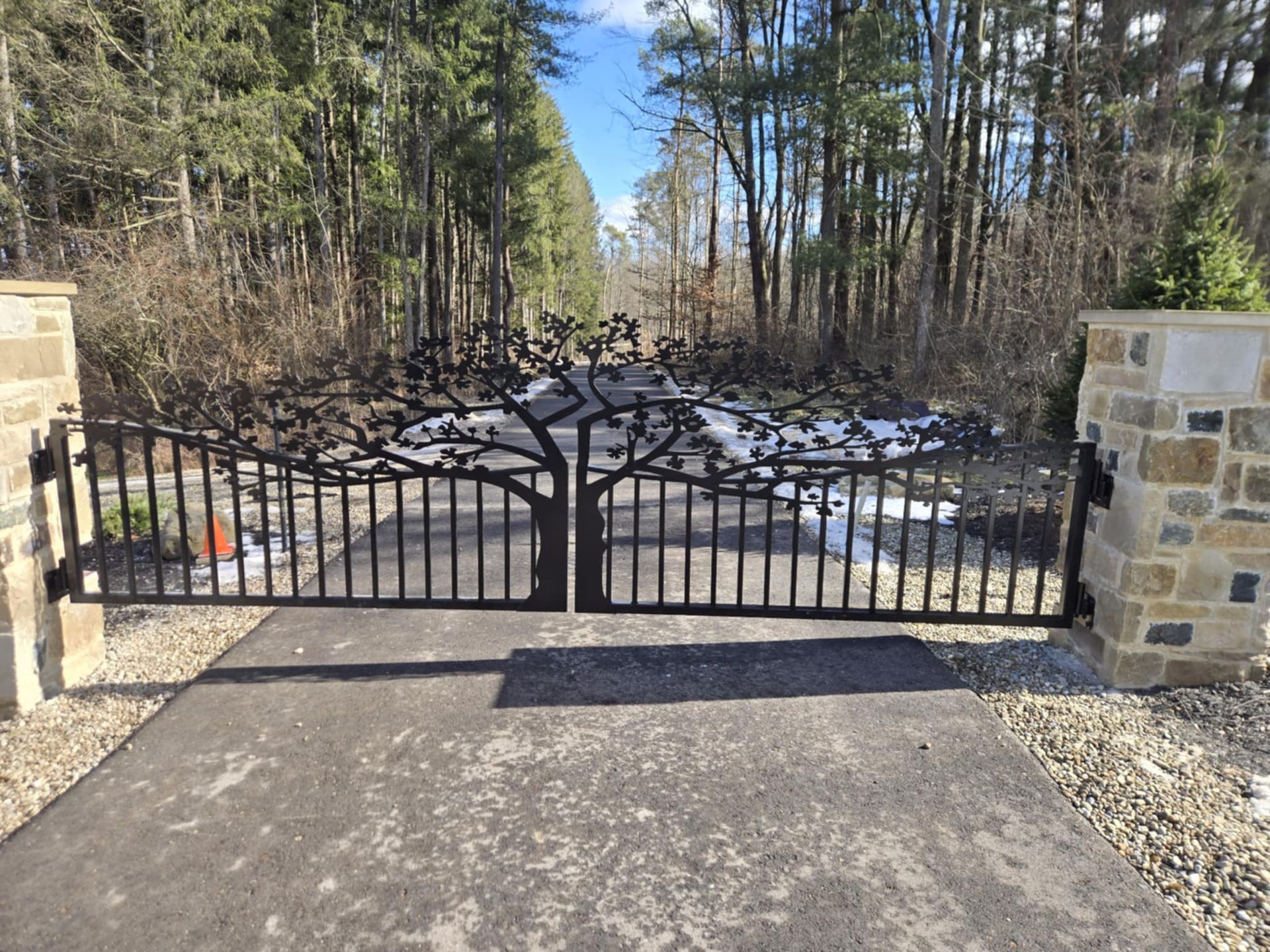 A wrought iron gate with a tree design on it