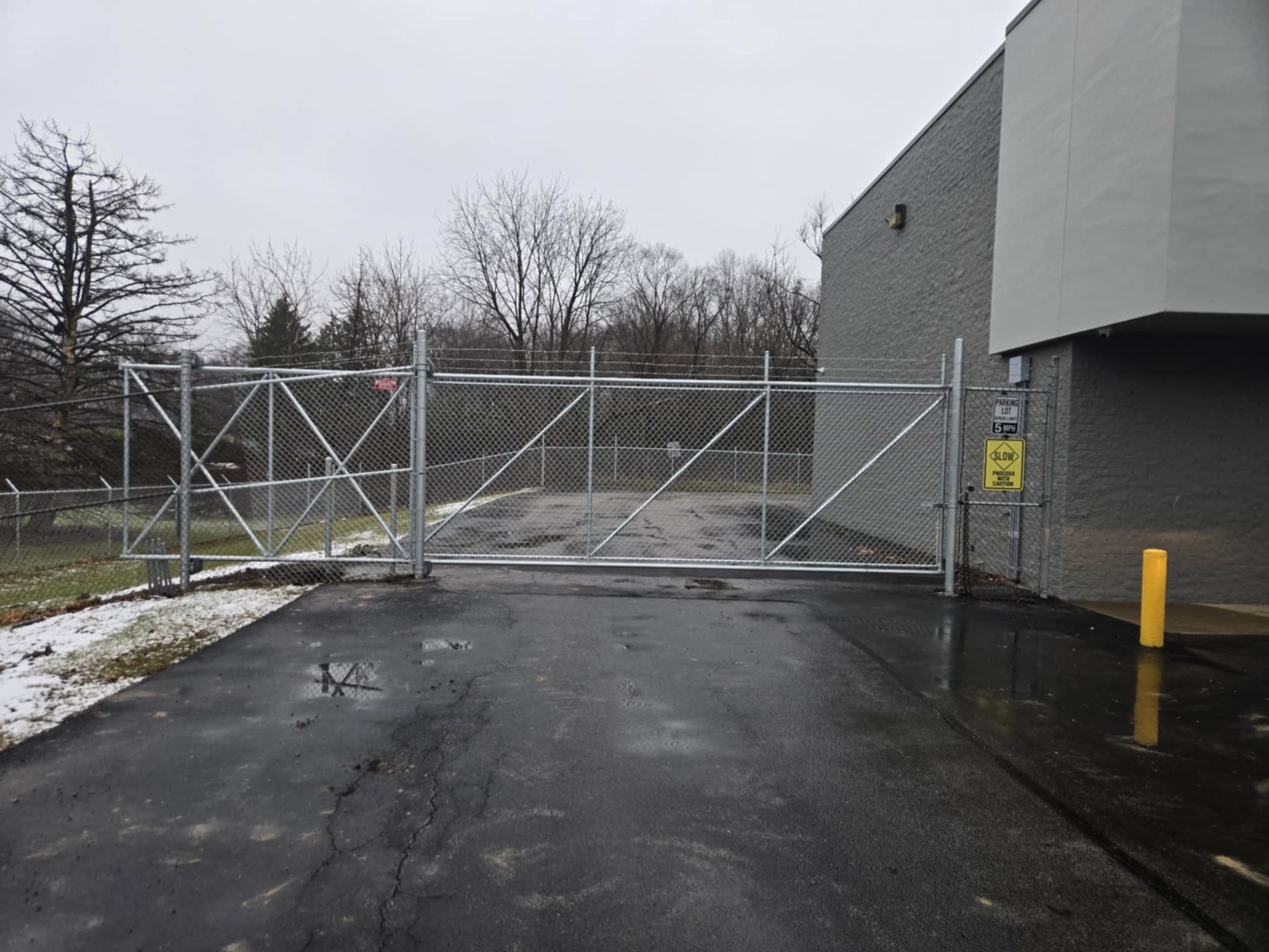 A gray building with a yellow sign that says no parking