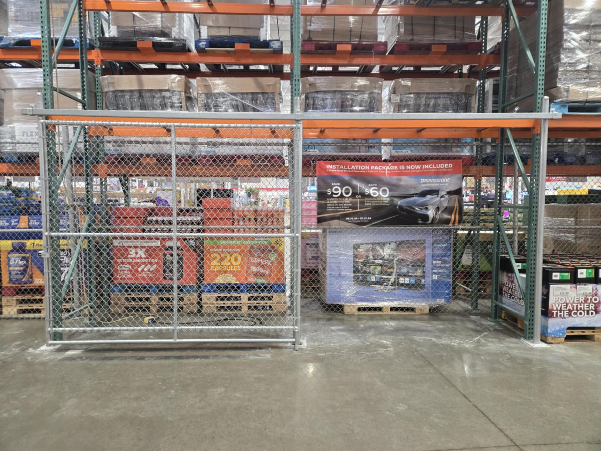 A warehouse with lots of shelves and a fence surrounding it