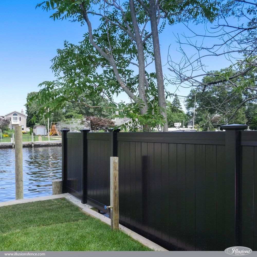 A black fence surrounds a body of water
