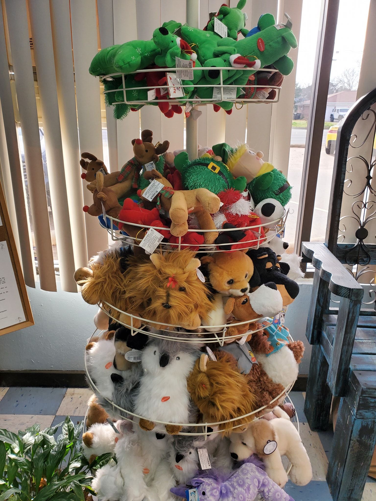 A display of stuffed animals on a pole in a store.