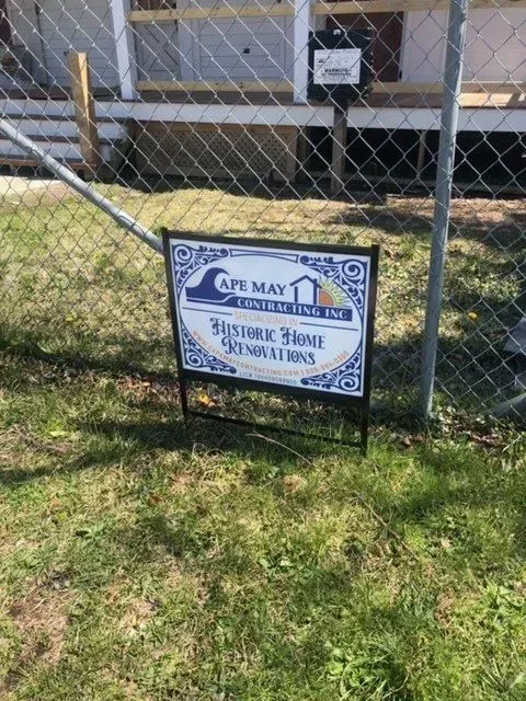 Sign for Cape May Center for Fine Arts Inc, promoting historic home renovations, in front of house.