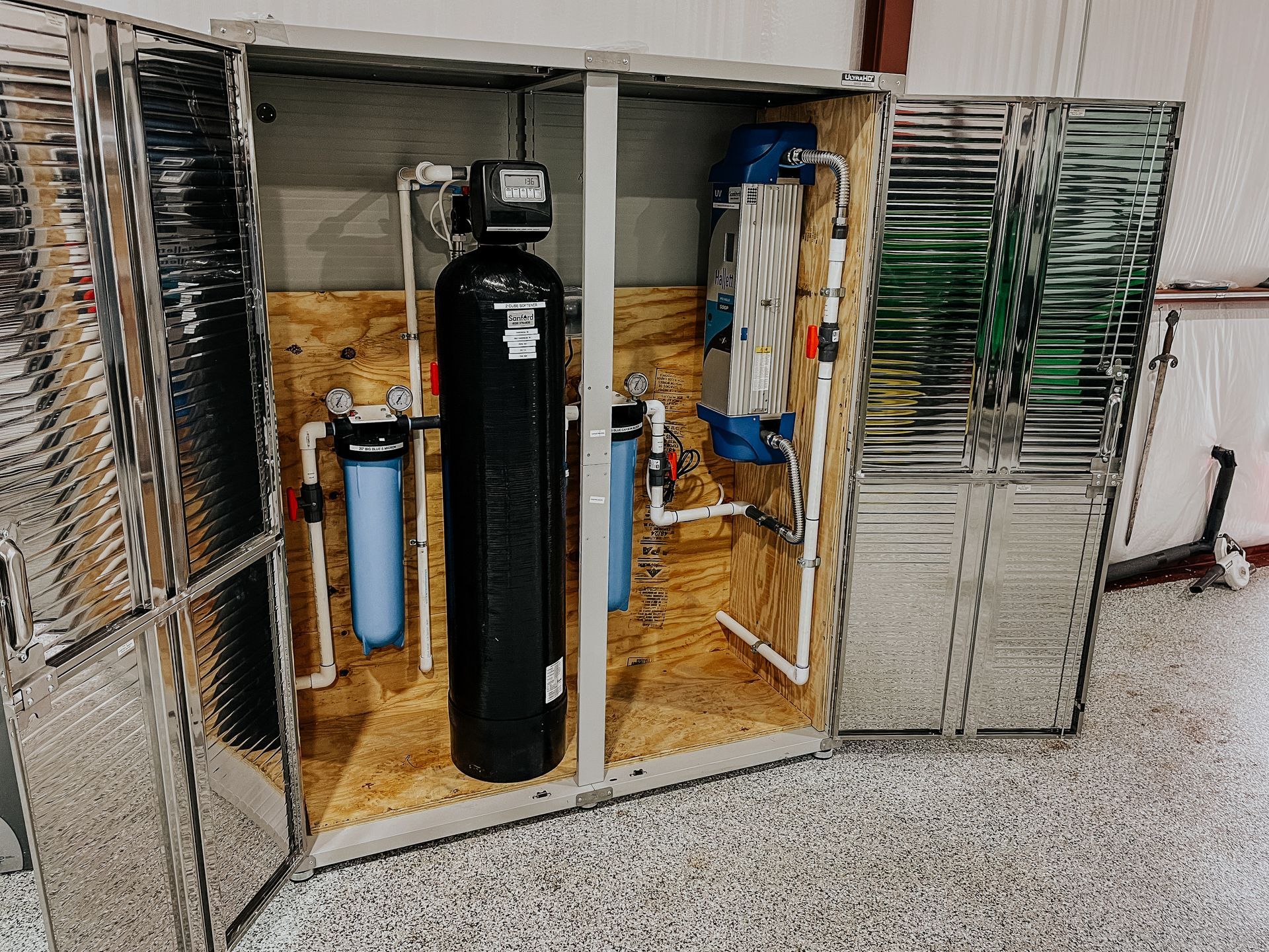 A rain catchment system is sitting inside of a metal locker.