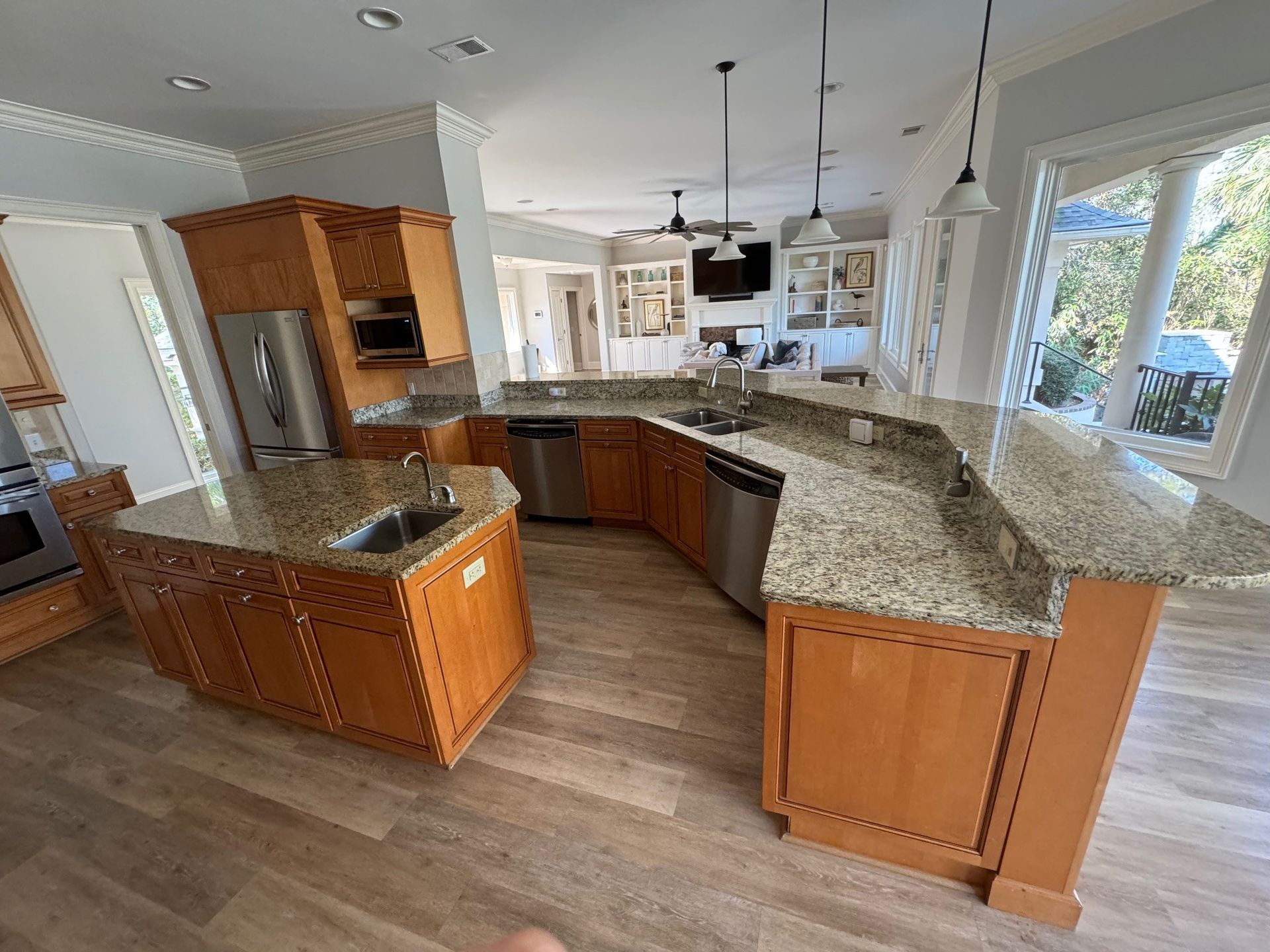Spacious kitchen with wood cabinets, granite countertops, and stainless steel appliances.