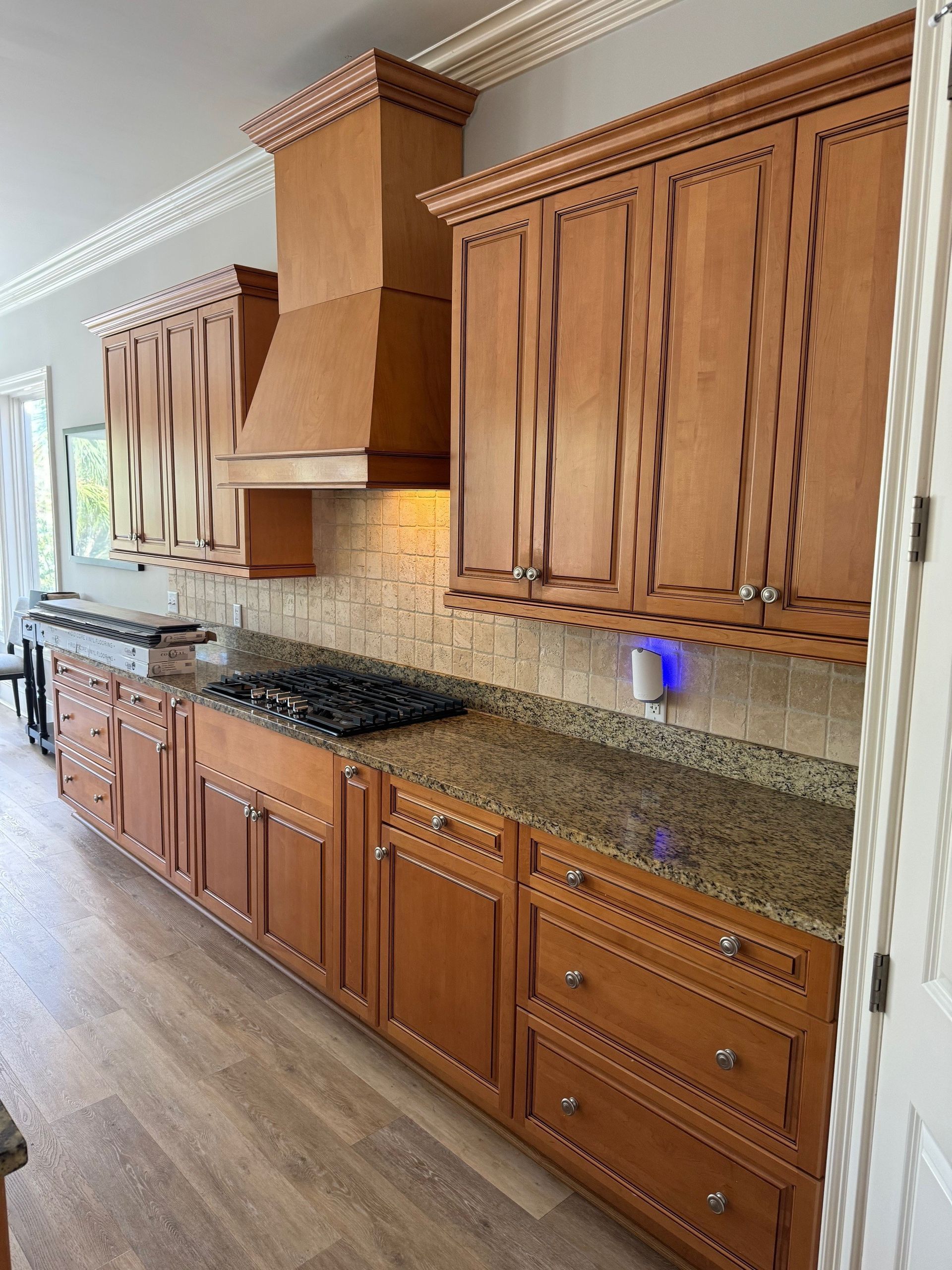 Spacious kitchen with wood cabinets, granite countertops, and a central island.