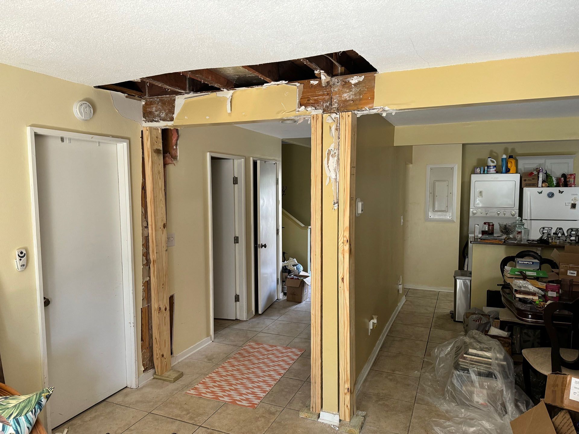 Termite Damage - Interior construction site; exposed beams, doorway, and unfinished walls; visible studs and exposed wood.