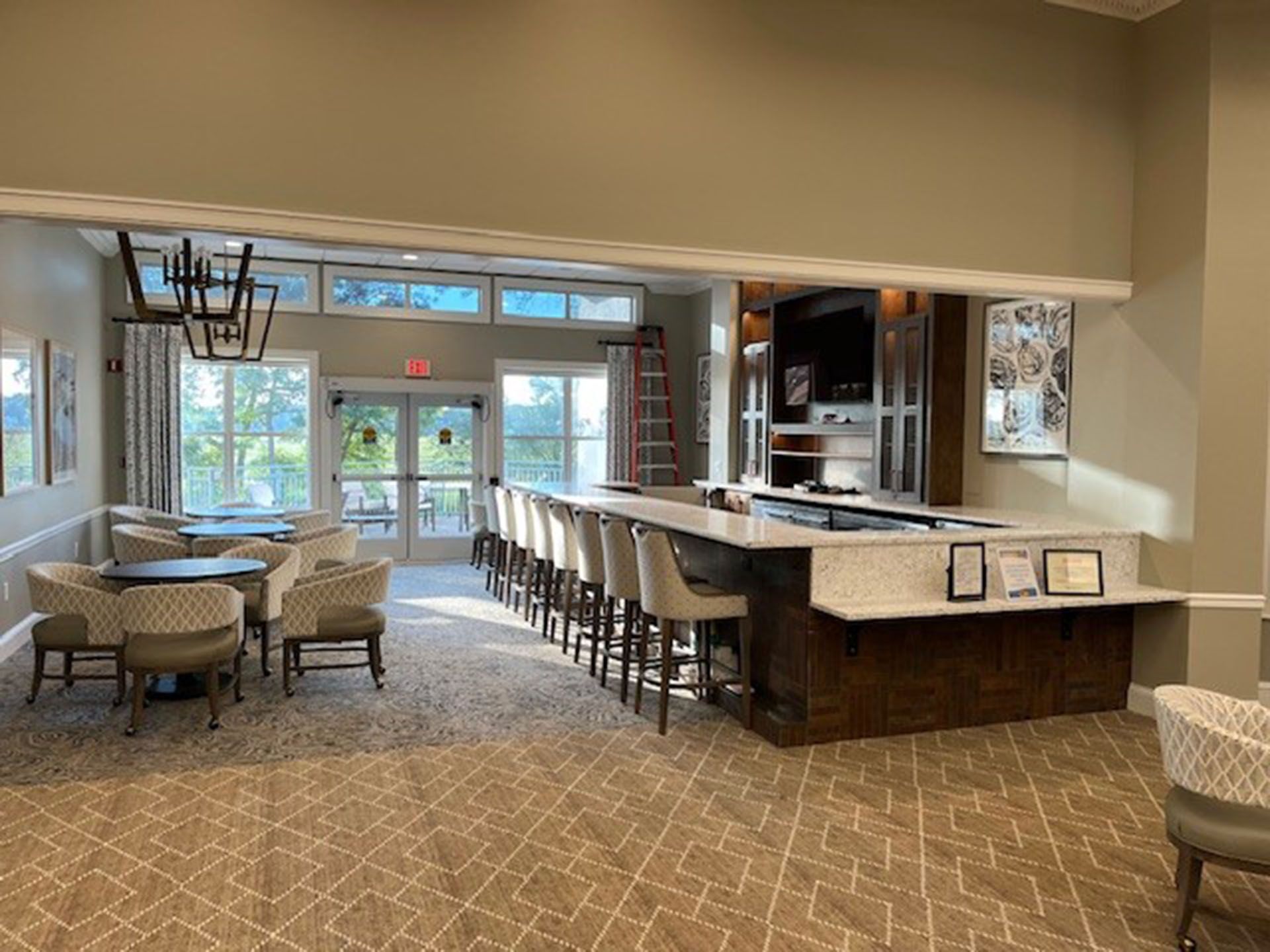 Commercial bar remodel - Interior bar with seating, doors to outside, light fixtures, and a TV.