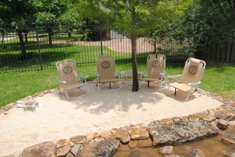 A group of chairs are sitting in a backyard.