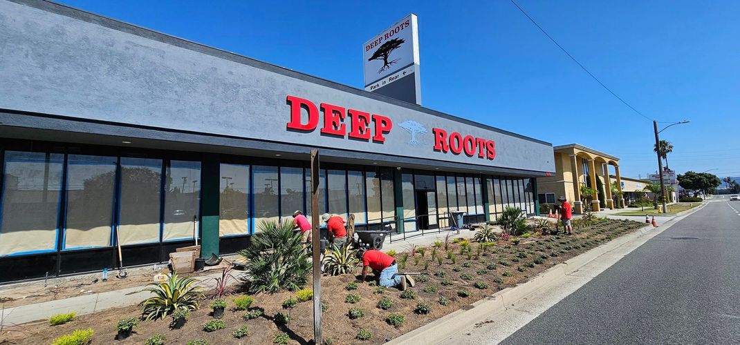 A large building with a red sign that says deep roots