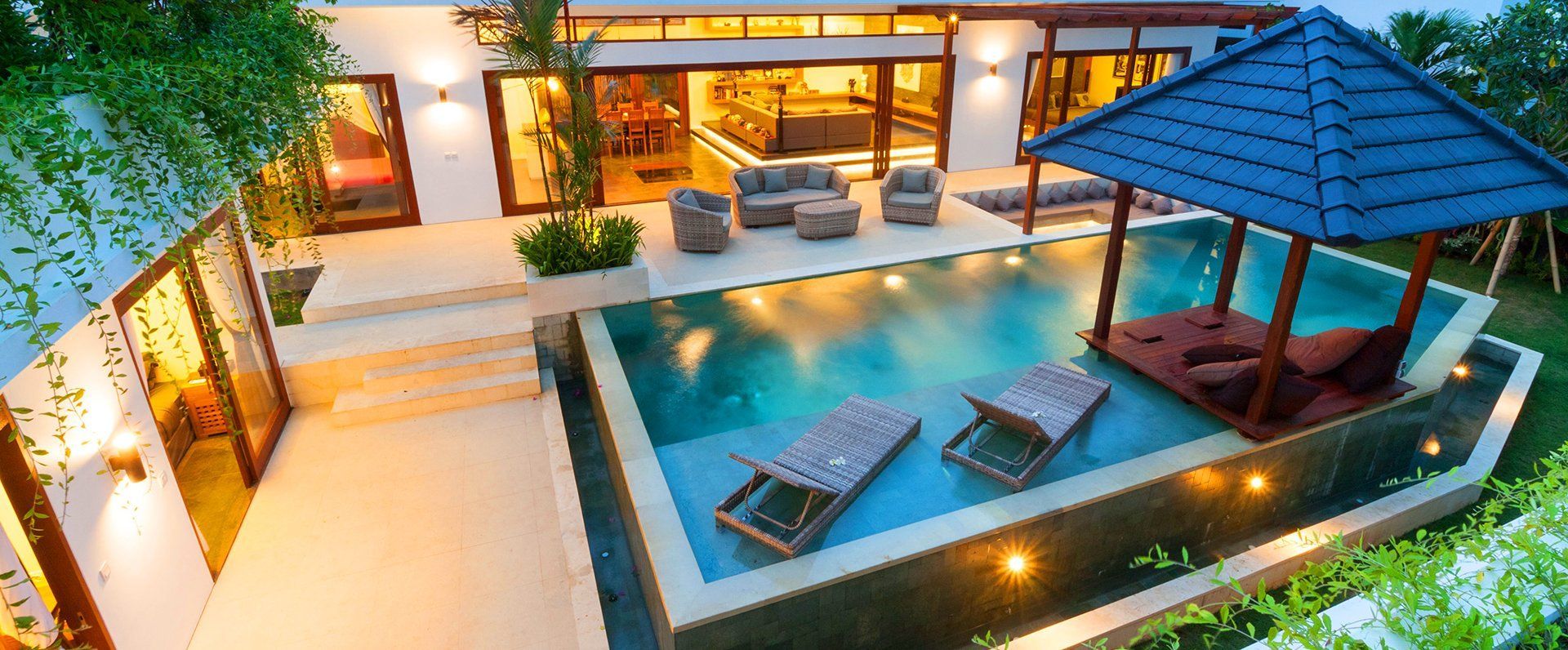A large swimming pool in the backyard of a house