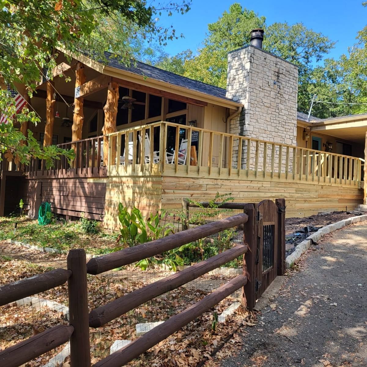A house with a wooden deck and a wooden fence