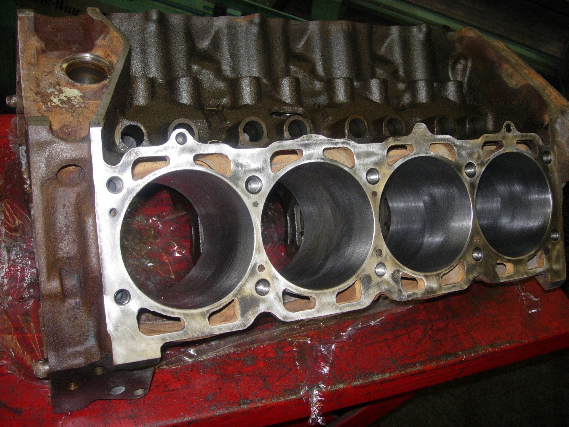 A close up of a cylinder block on a red table