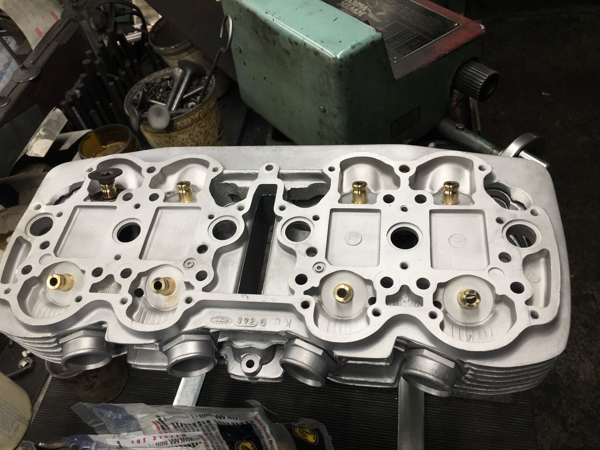 The cylinder head of a car is sitting on a table.