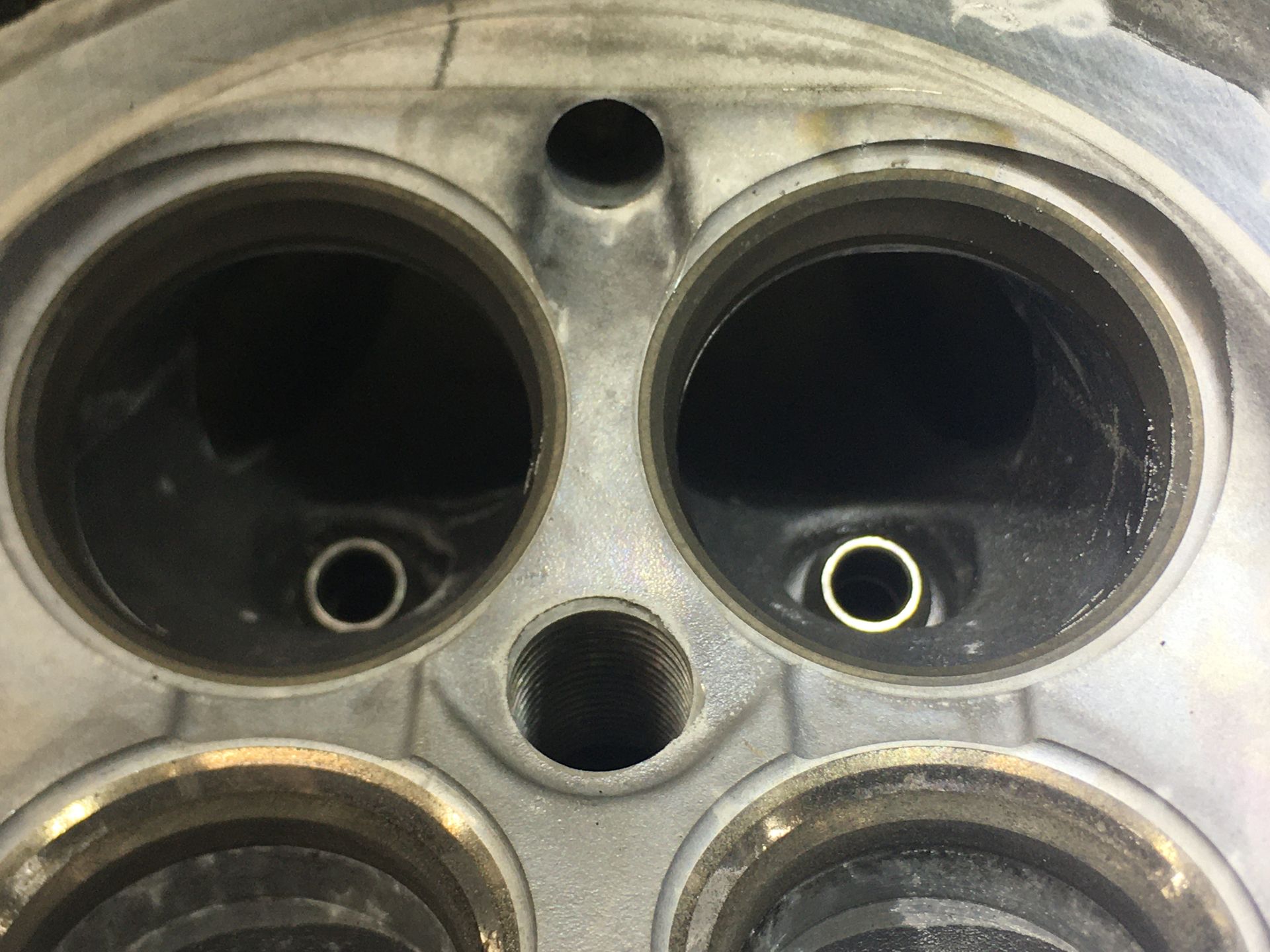 A close up of a metal object with four holes in it.