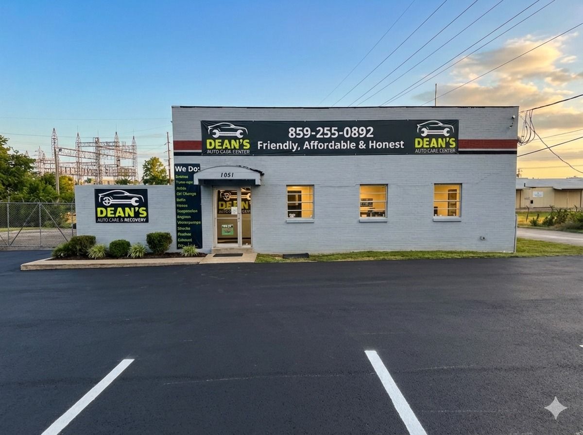 Dean's storefront with sign, windows, and parking lot at sunset