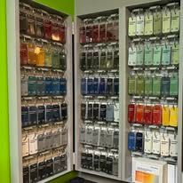 A cabinet filled with lots of different colored paints.