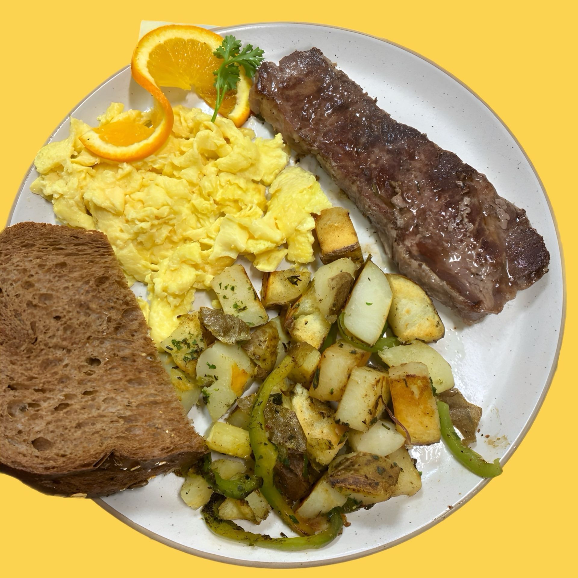 A white plate topped with scrambled eggs steak potatoes and toast