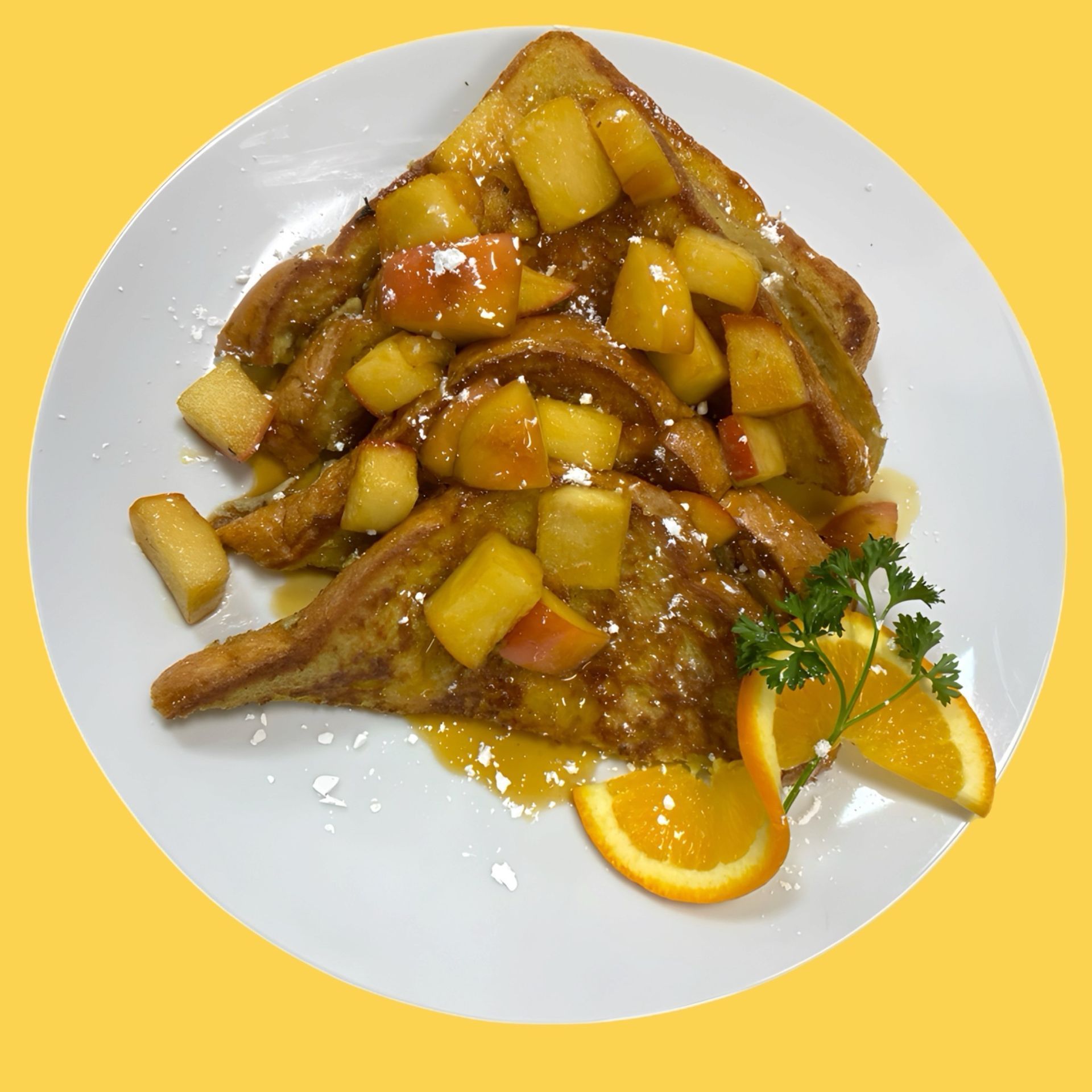 French toast with apples and oranges on a white plate