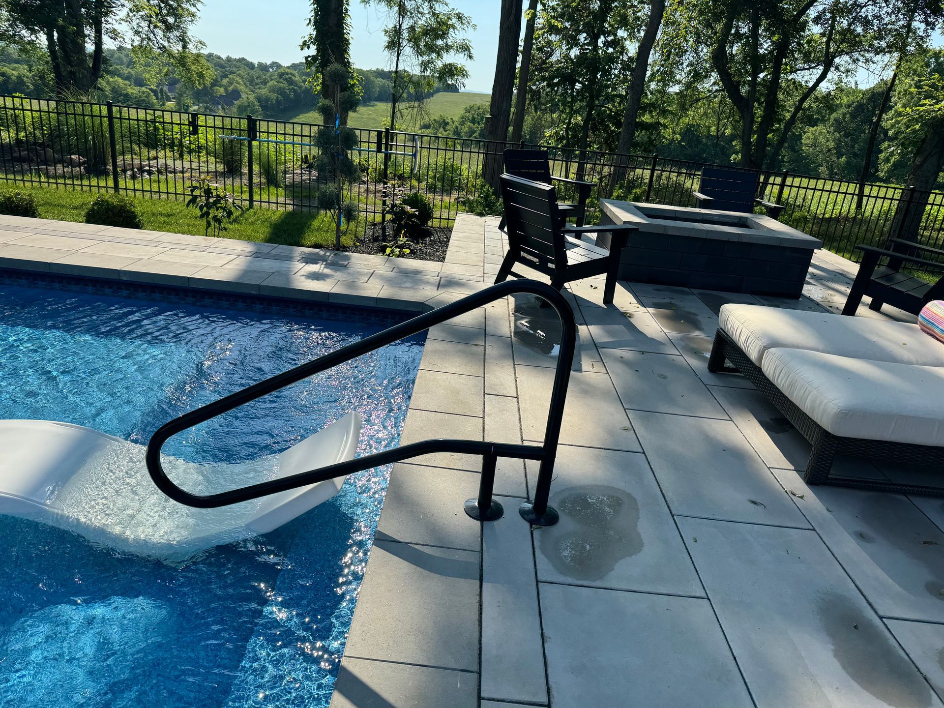 A swimming pool with a staircase leading to it