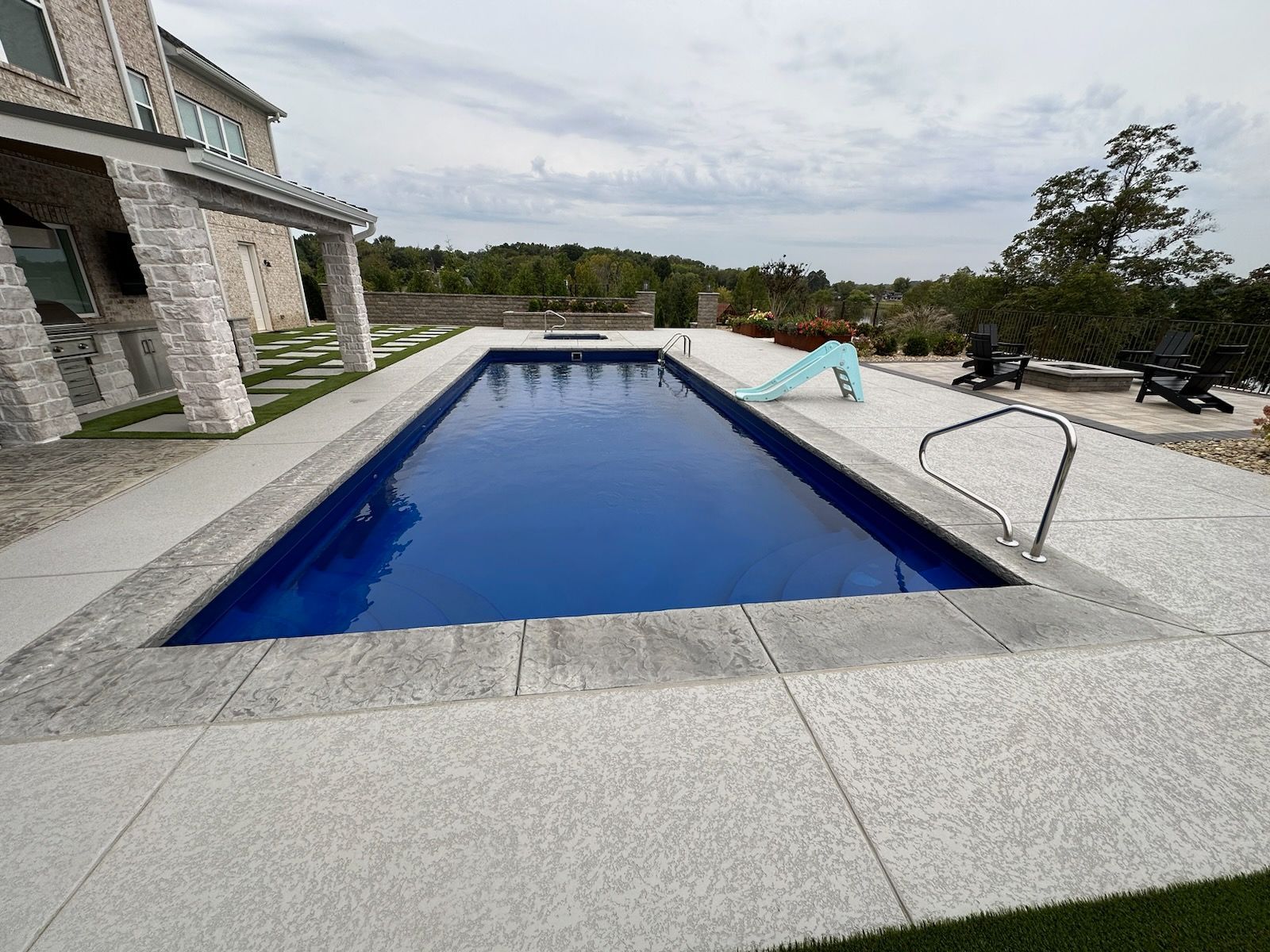 A large swimming pool in front of a house