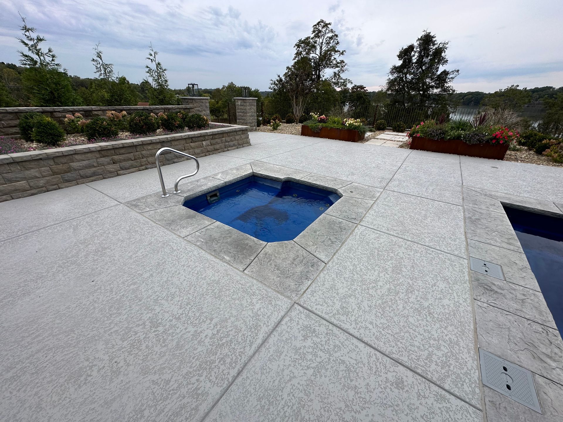 A pool with a hot tub in the middle of it