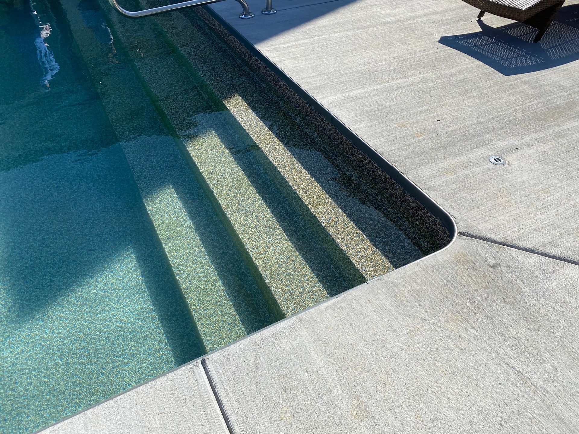 A swimming pool with stairs leading up to it