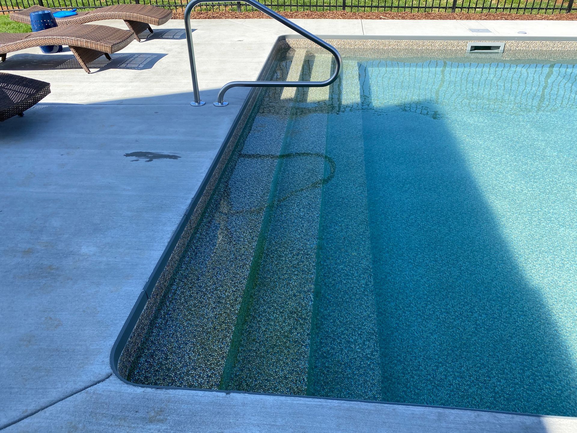 A swimming pool with stairs leading up to it