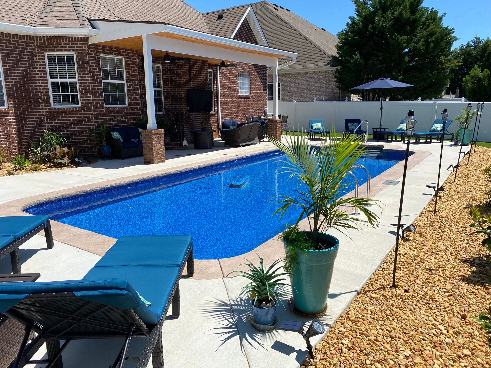 A large swimming pool in the backyard of a house