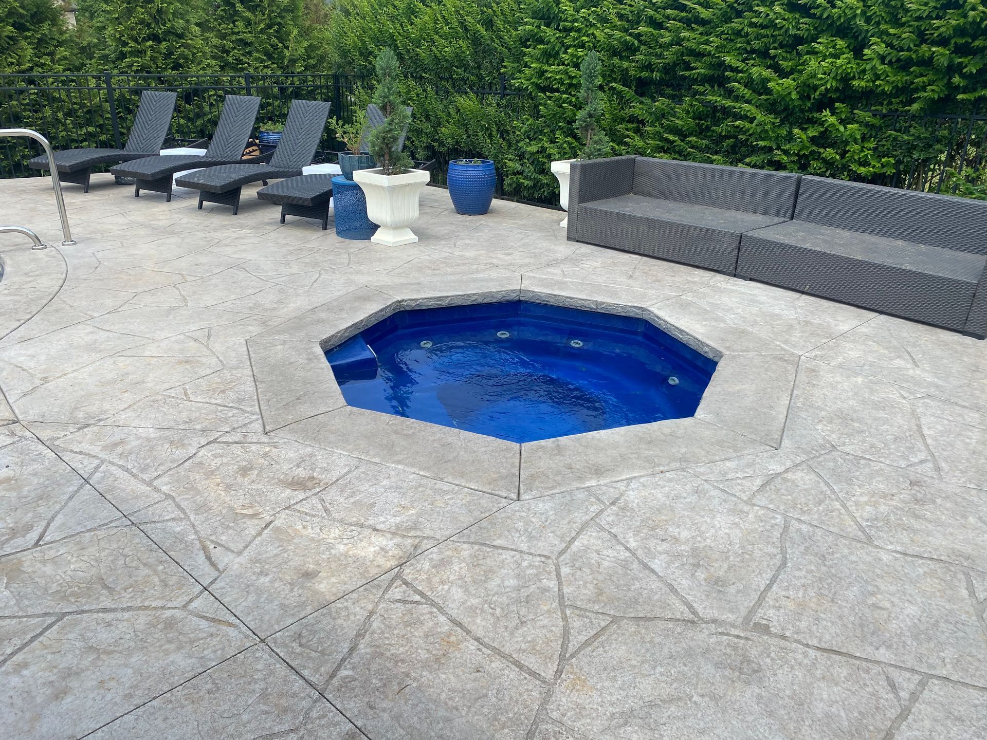 There is a hot tub in the middle of the patio.