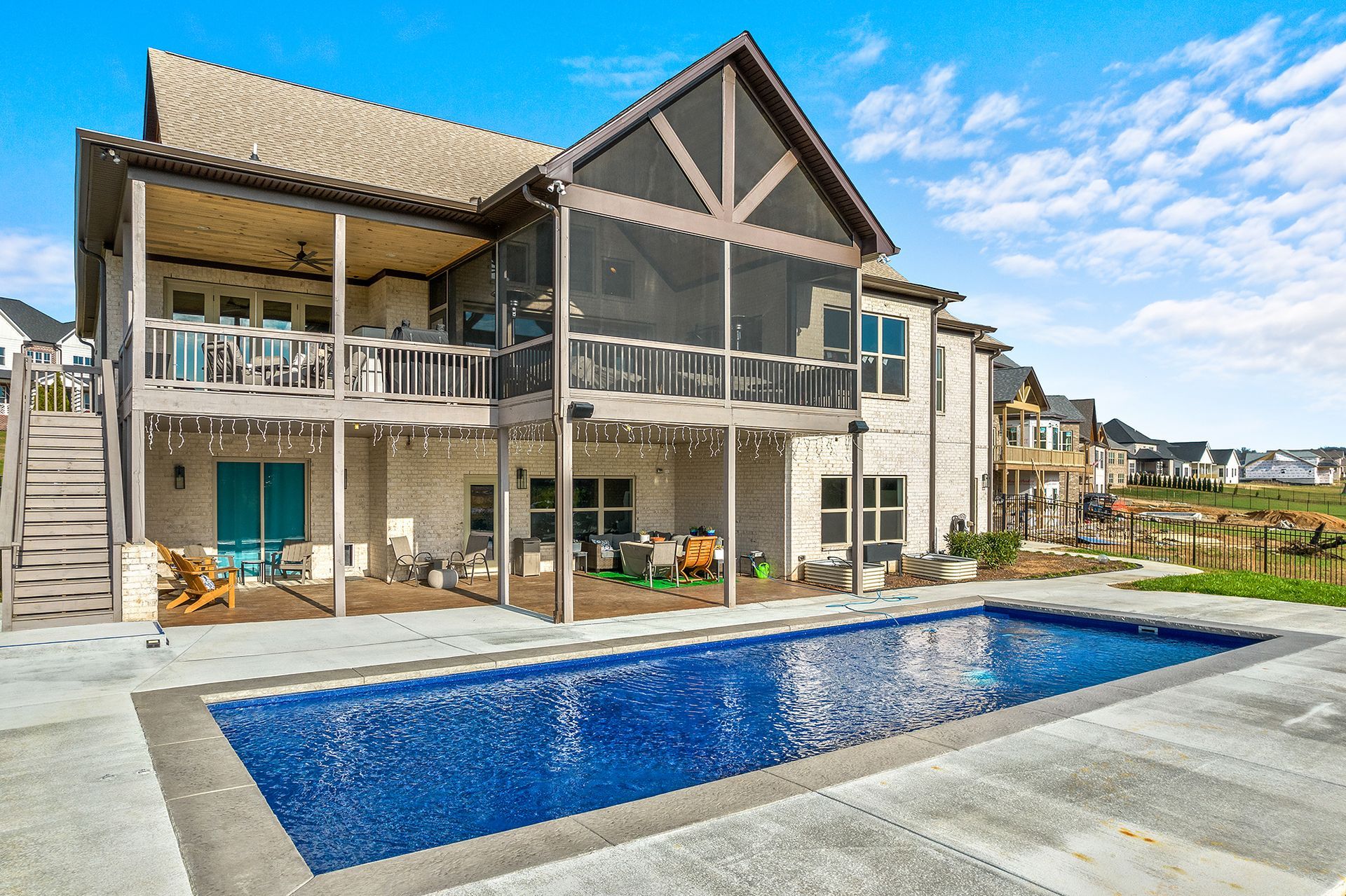 A large house with a large swimming pool in front of it
