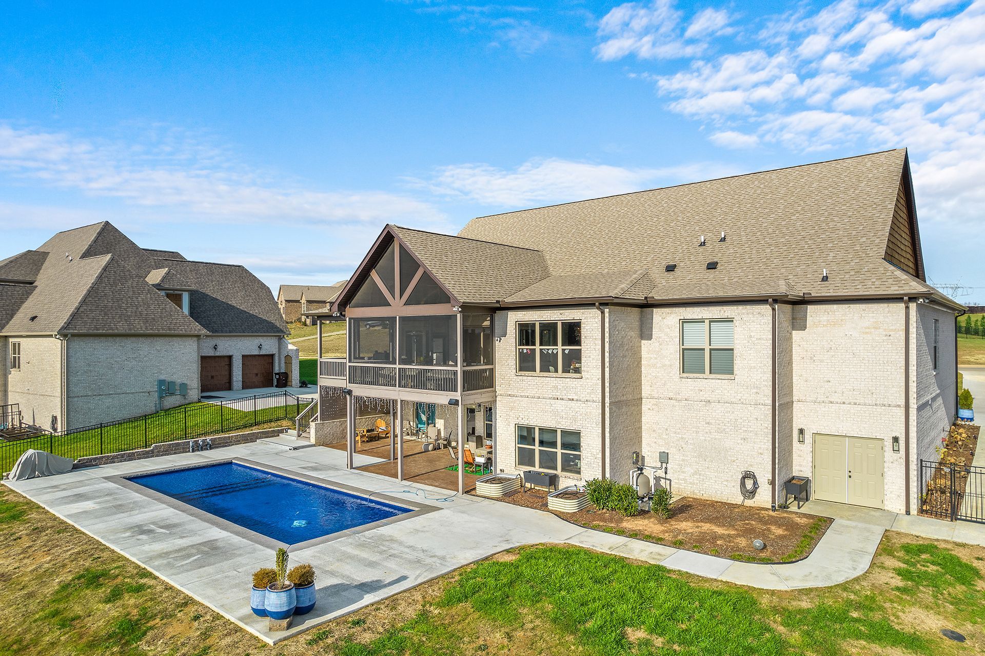A large house with a large swimming pool in the backyard.