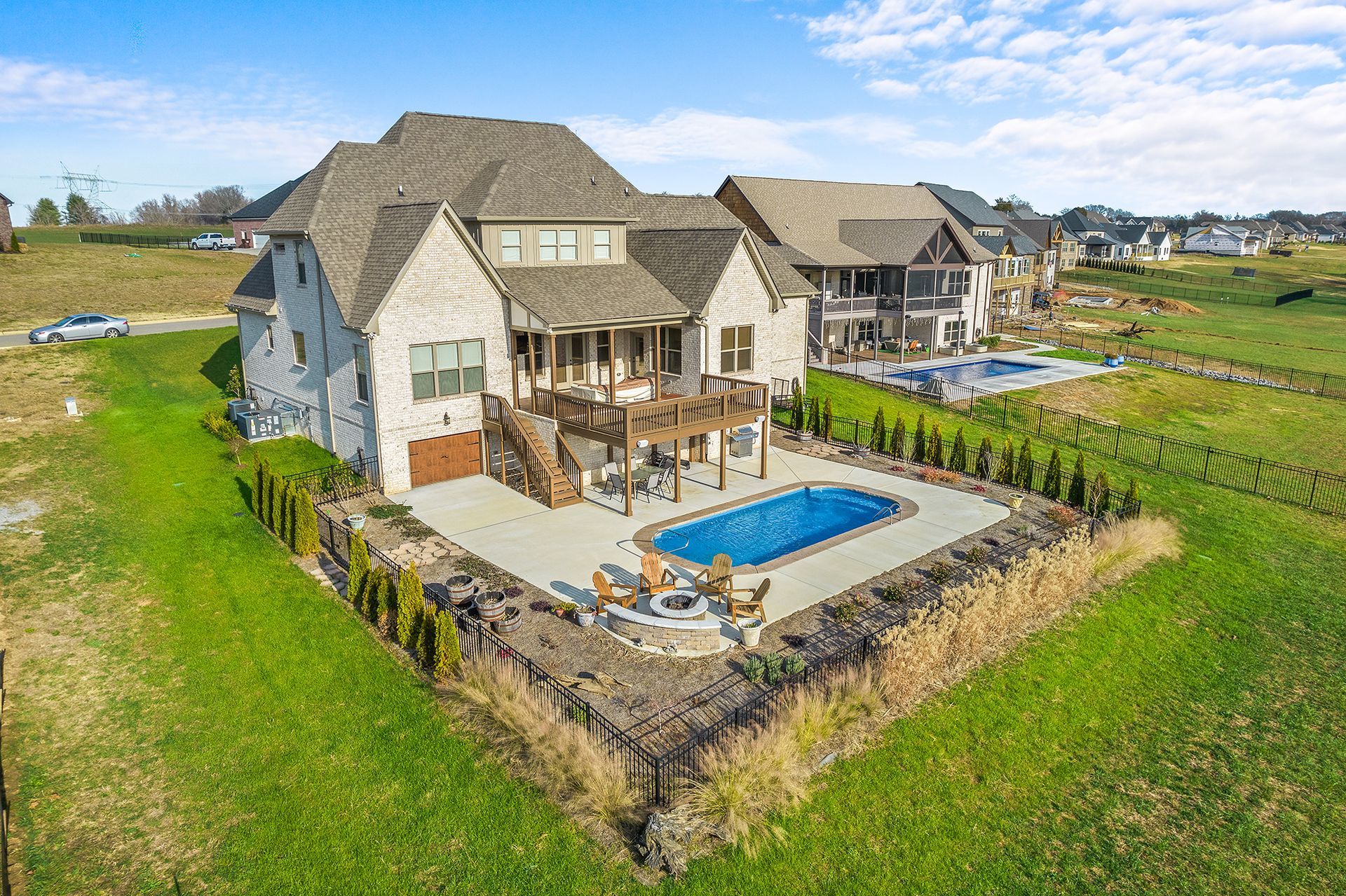An aerial view of a large house with a pool in the backyard.