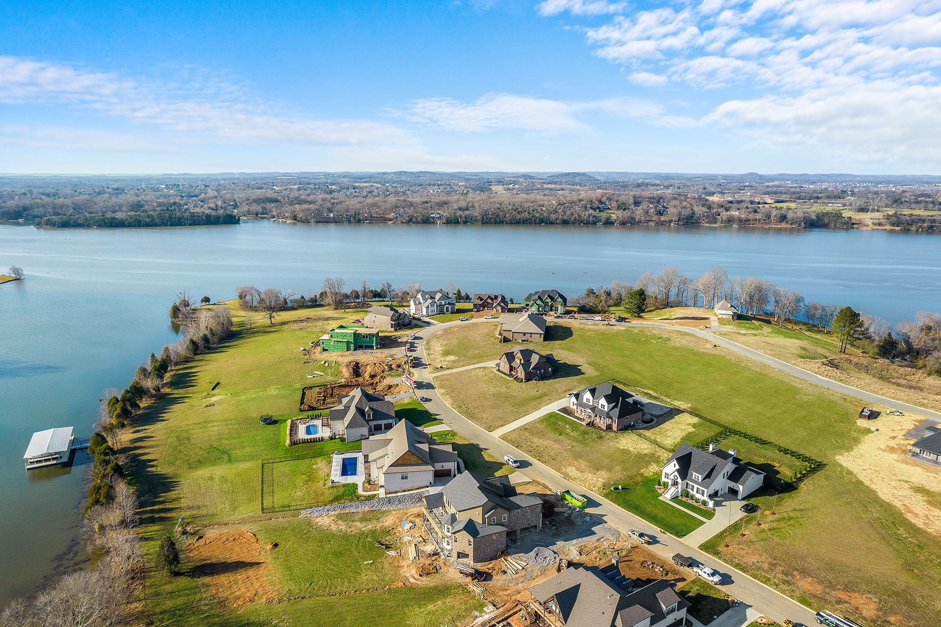 An aerial view of a residential area next to a lake.