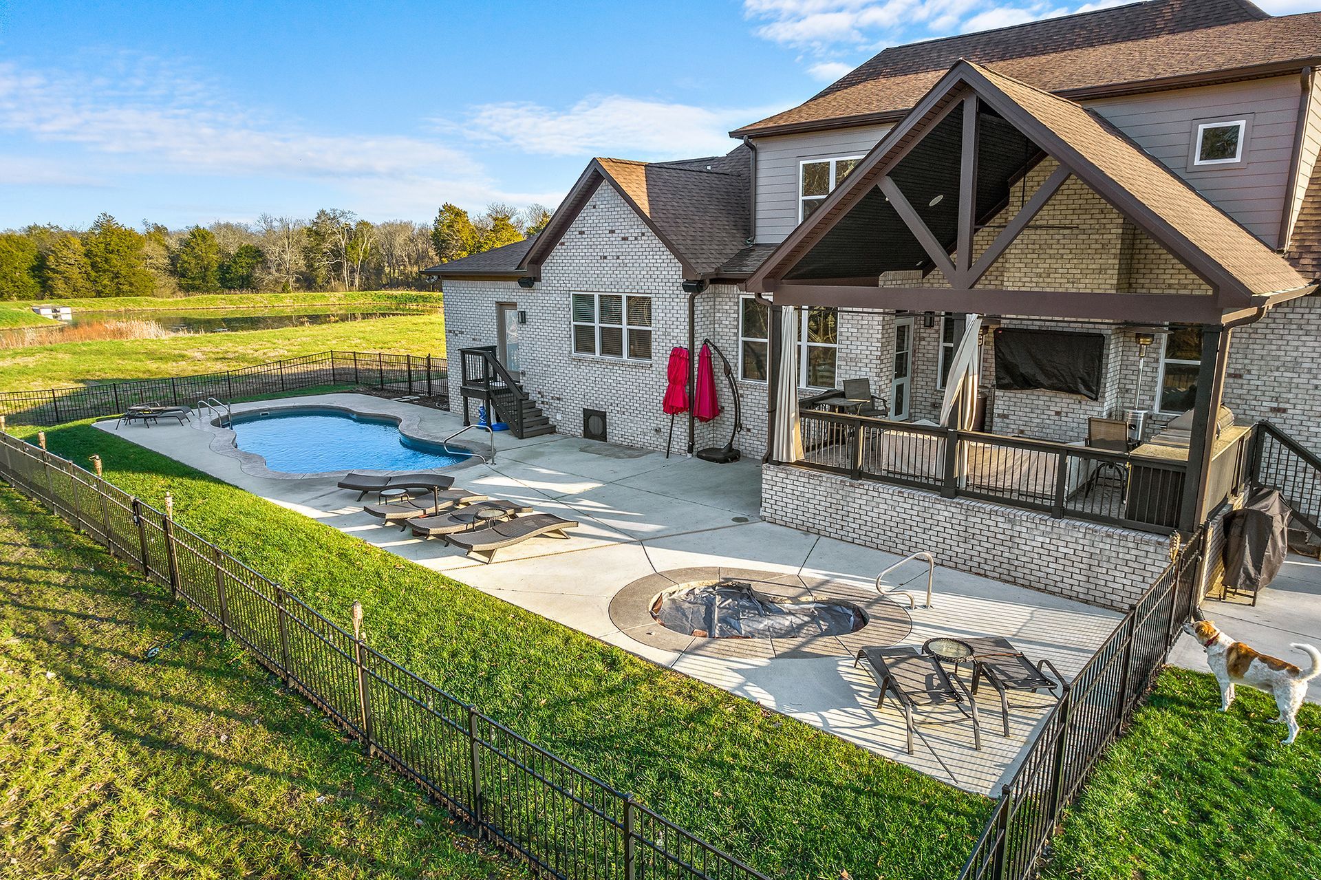 A large house with a swimming pool and a fence around it.
