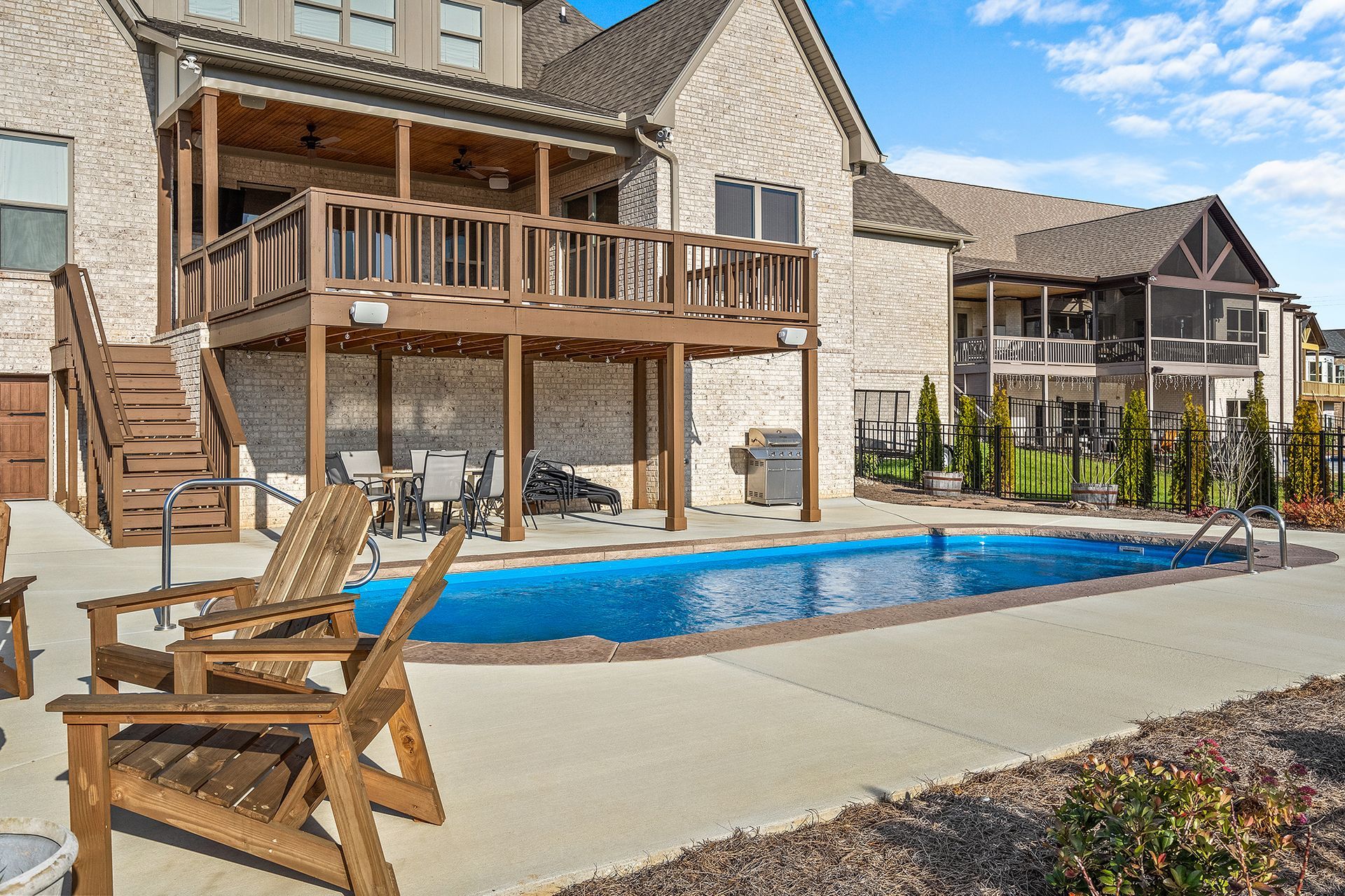 A large house with a large swimming pool in front of it.