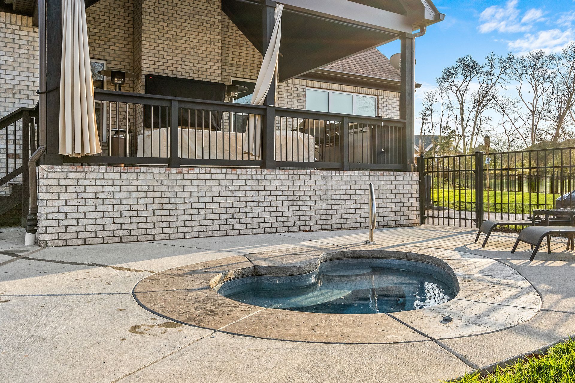 There is a hot tub in the backyard of a house.
